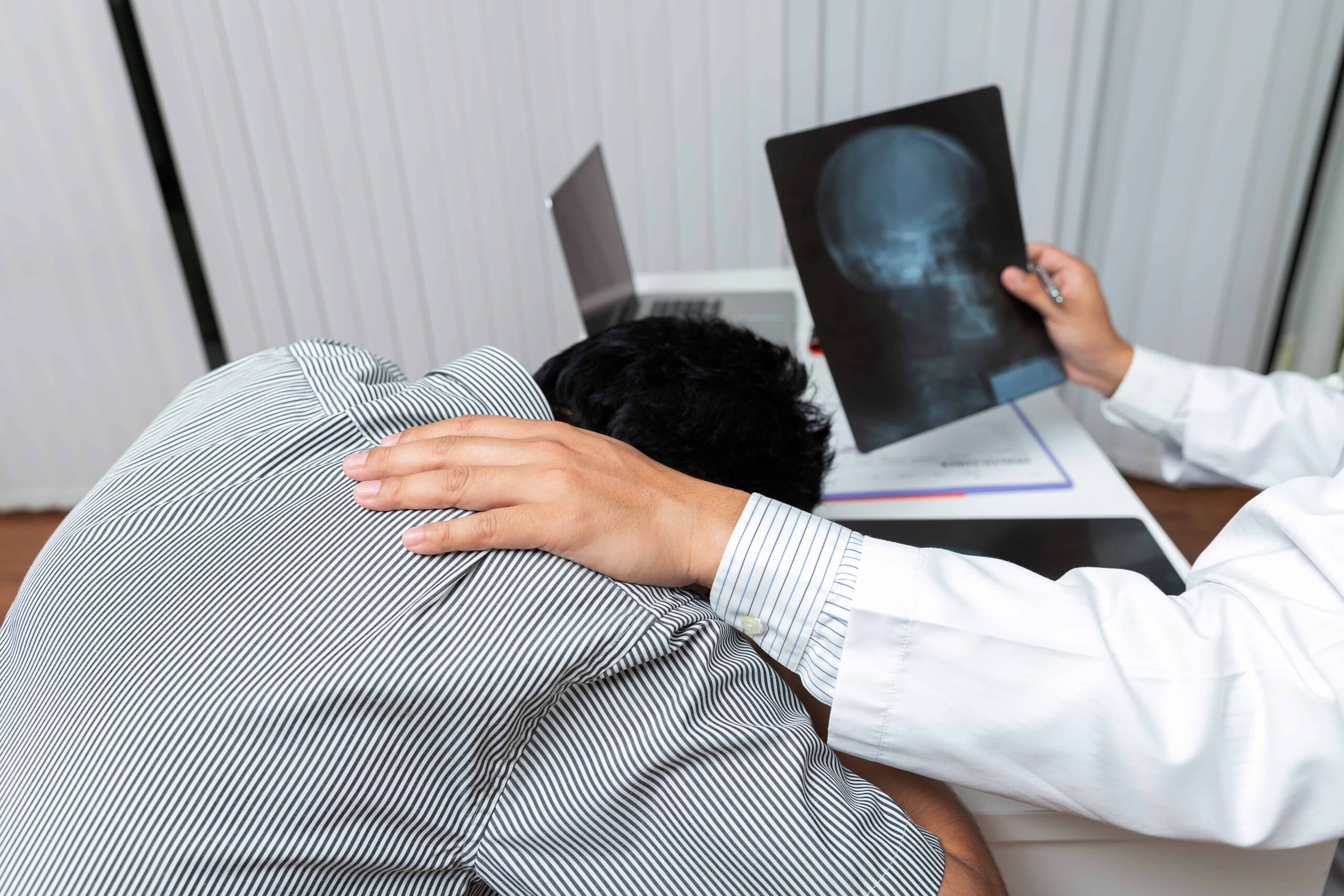 doctor consoling patient after x-ray shows failed diagnosis